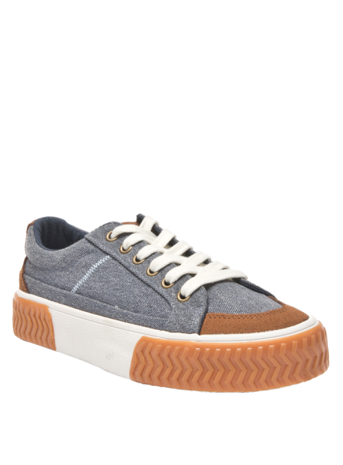 Zapatilla azul casual de mujer con suela gruesa zigzag y detalles en textil y cuero de estilo urbano.
