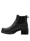 Diseño minimalista de botín negro Chelsea para mujer, con suela antideslizante y tacón medio cuadrado para estabilidad.