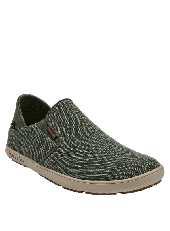 Calzado masculino urbano en gris oscuro, textil con etiqueta discreta, suela beige contrastante.