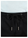 Cintura del short negro ajustable, resalta su calce cómodo.